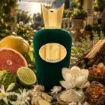 Perfume bottle surrounded by fruits.